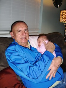 Grampy is cuddling Elizabeth.